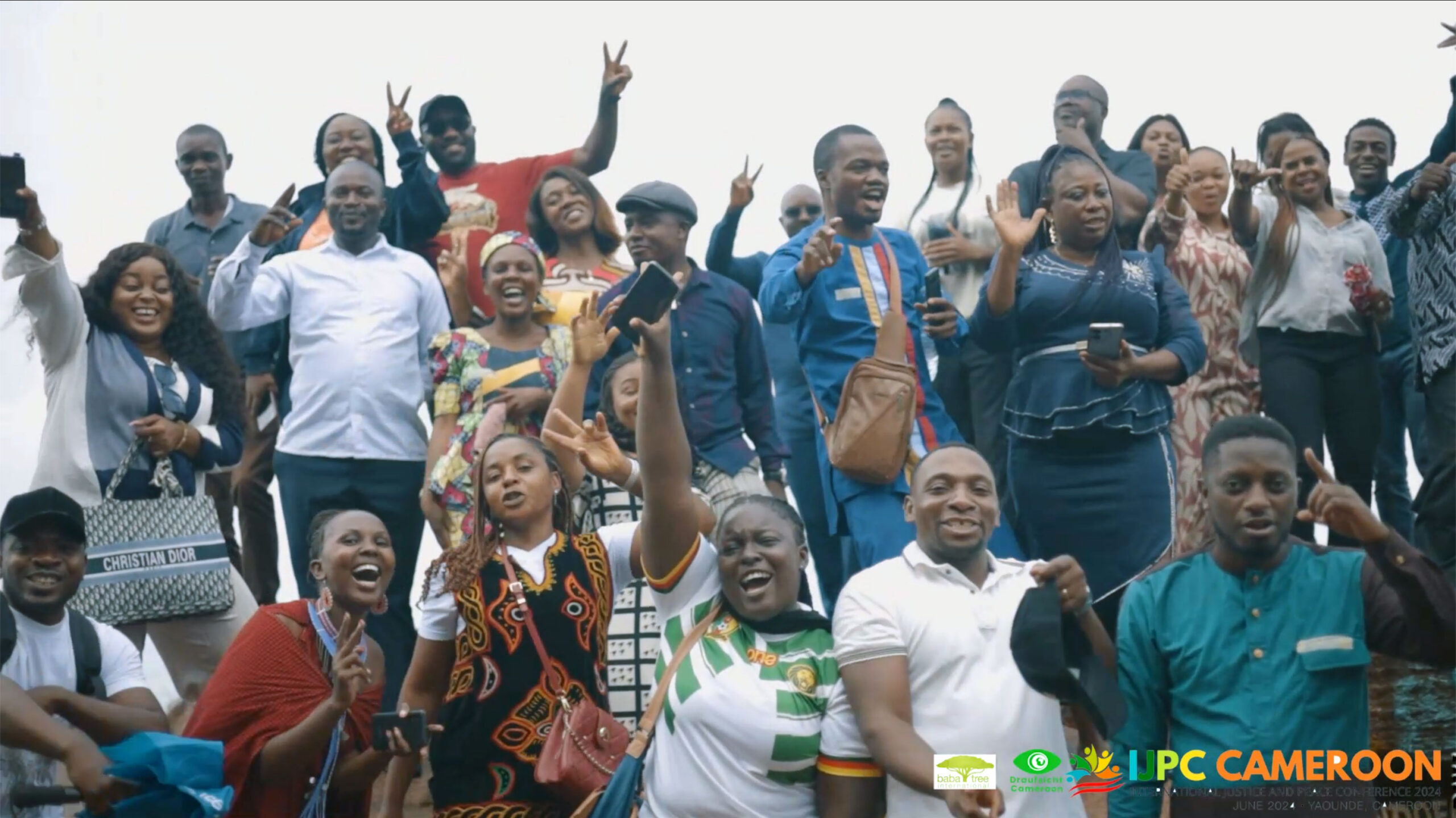 Participants of International Justice and Peace Conference cheering